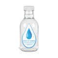 Clear glass water bottle with 'Touch of Heaven' label on a white background