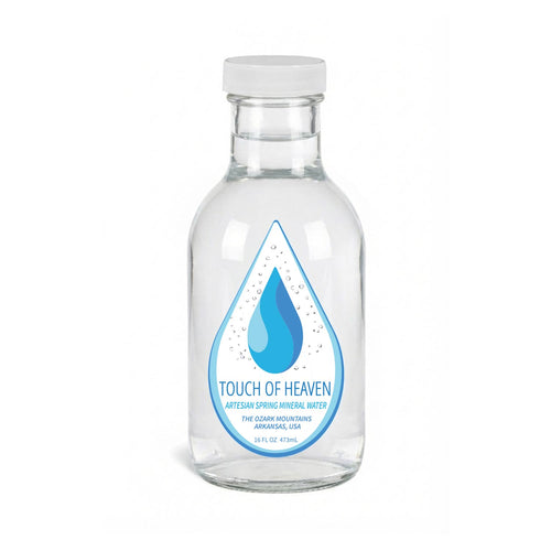 Clear glass water bottle with 'Touch of Heaven' label on a white background
