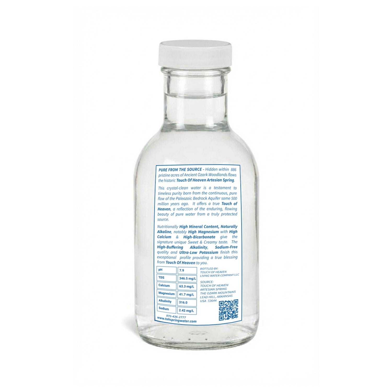 Clear glass water bottle with a label on a white background