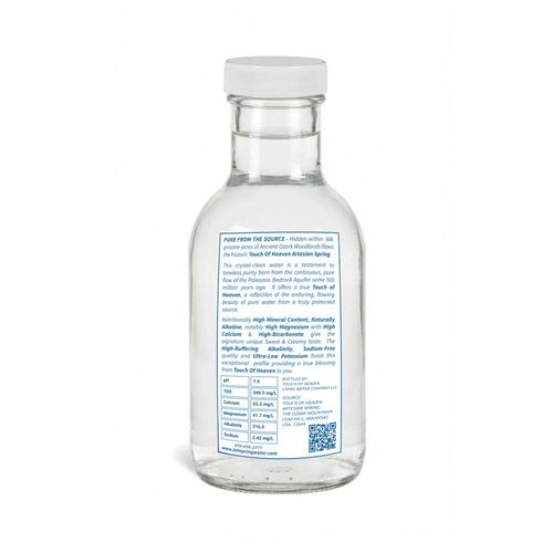 Clear glass water bottle with a label on a white background